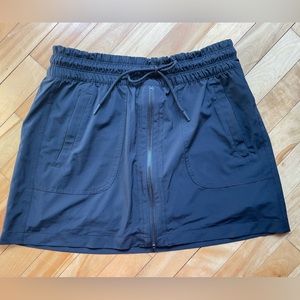Athleta Expedition black skort with drawstring and zipper detail. Size 8